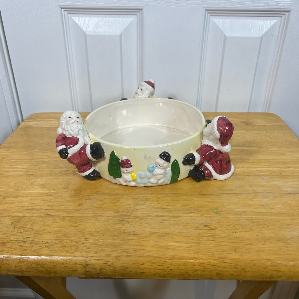 Santa Clause round Christmas dish. 8” wide, 2 1/4” deep. Ceramic with 3 Santa’s